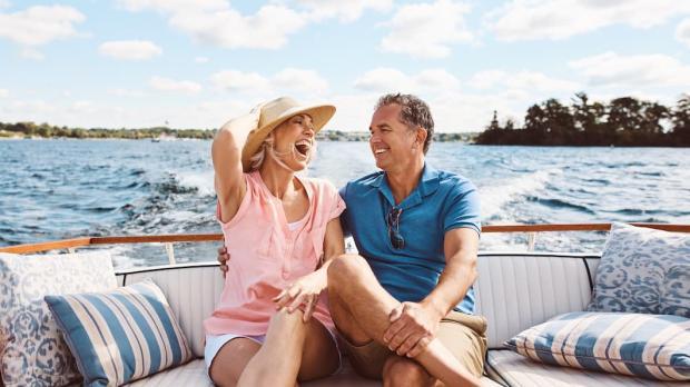 Wealthy couple laughing on a boat