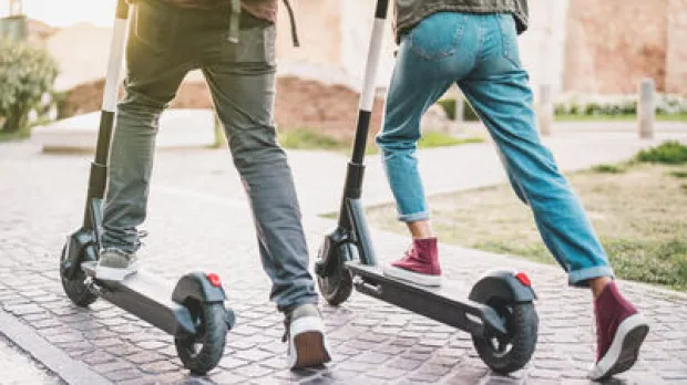 two people on e scooters