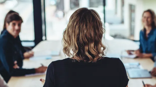 woman in front of colleagues