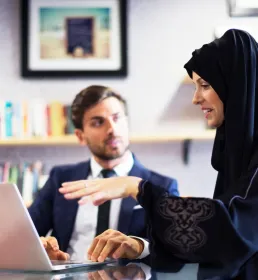 Financial businesswoman talking to her collegue