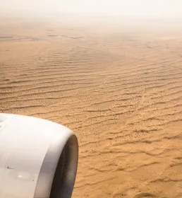 Plane flying over a desert
