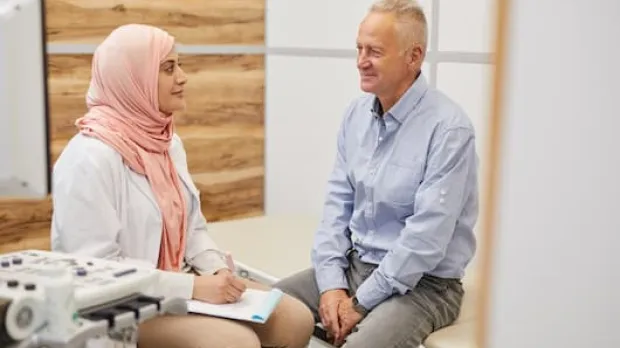Female doctor with elderly male patient