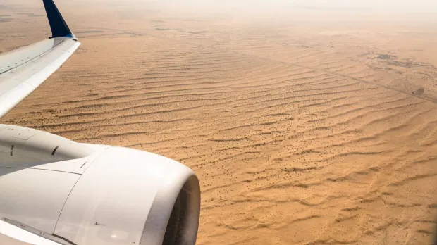 Plane flying over a desert