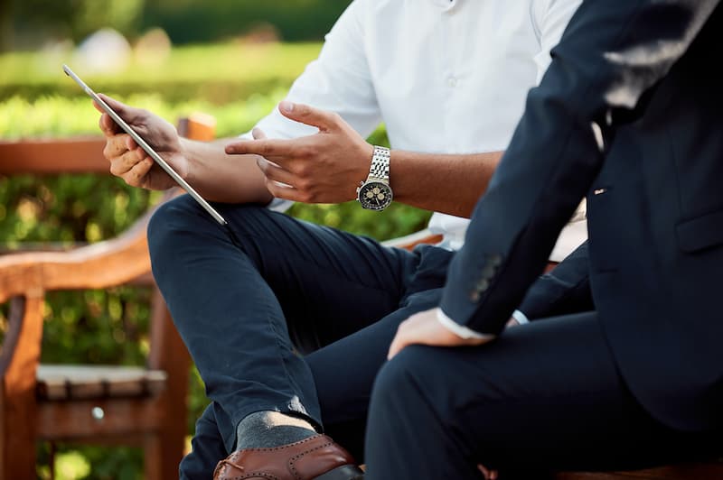 two businessmen discussing work outside