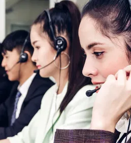 Call centre operatives wearing headphones