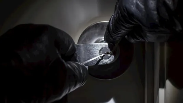 Criminal picking a lock Criminal picking a lock