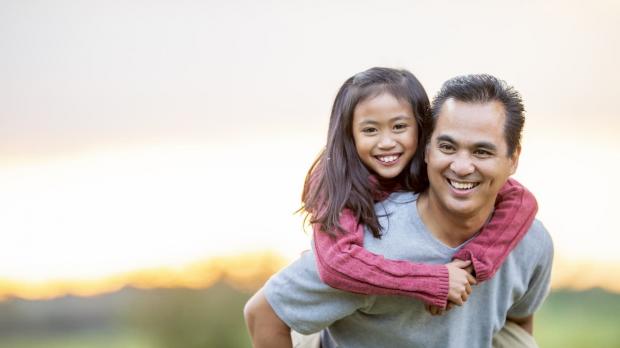 Man with daughter on his back