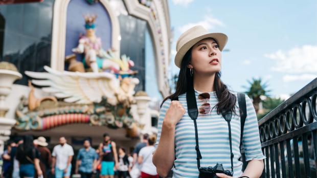 Young traveller exploring an international destination, symbolising confidence and protection through group travel insurance.