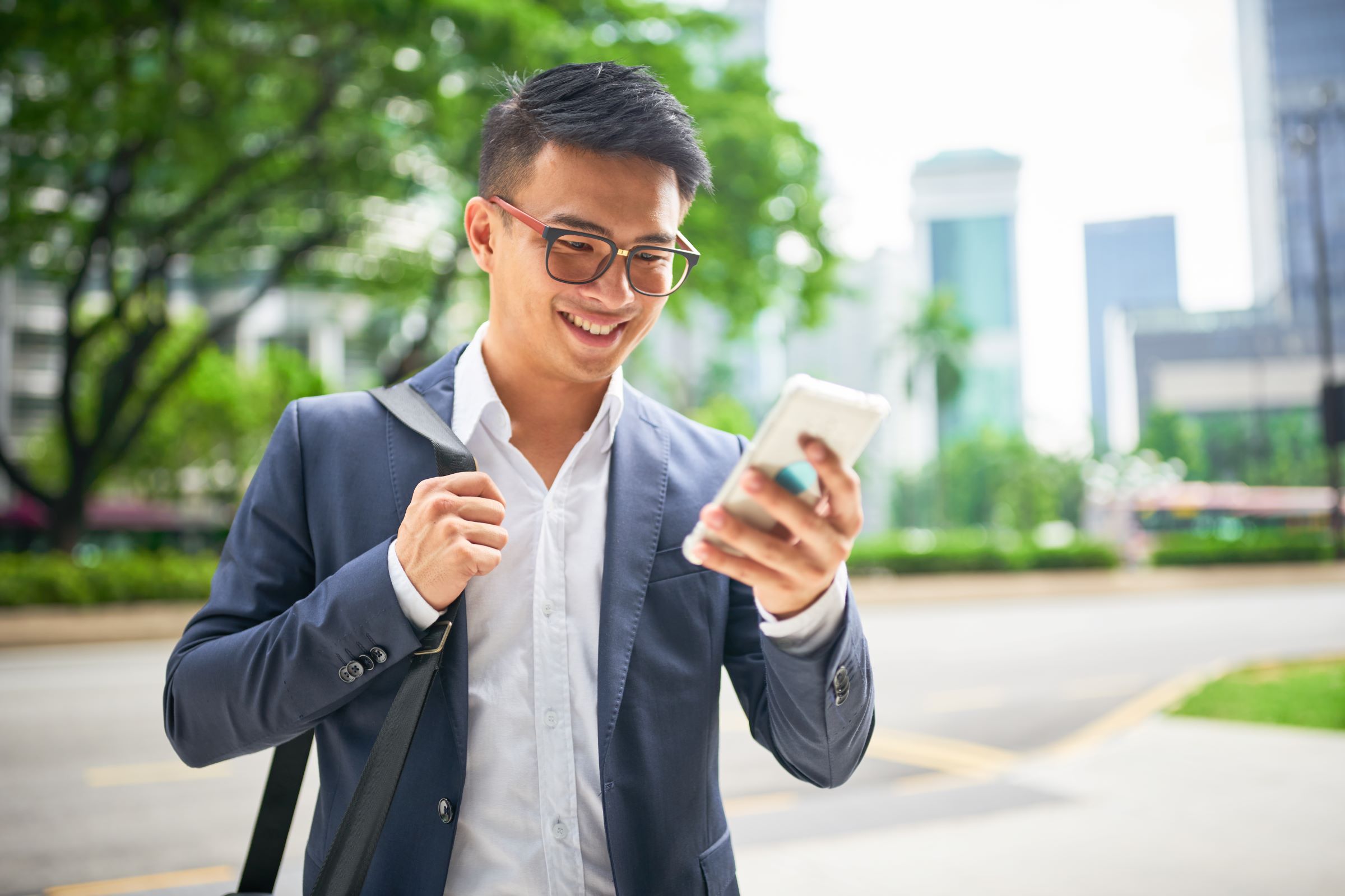 Young asian businessman on smartphone