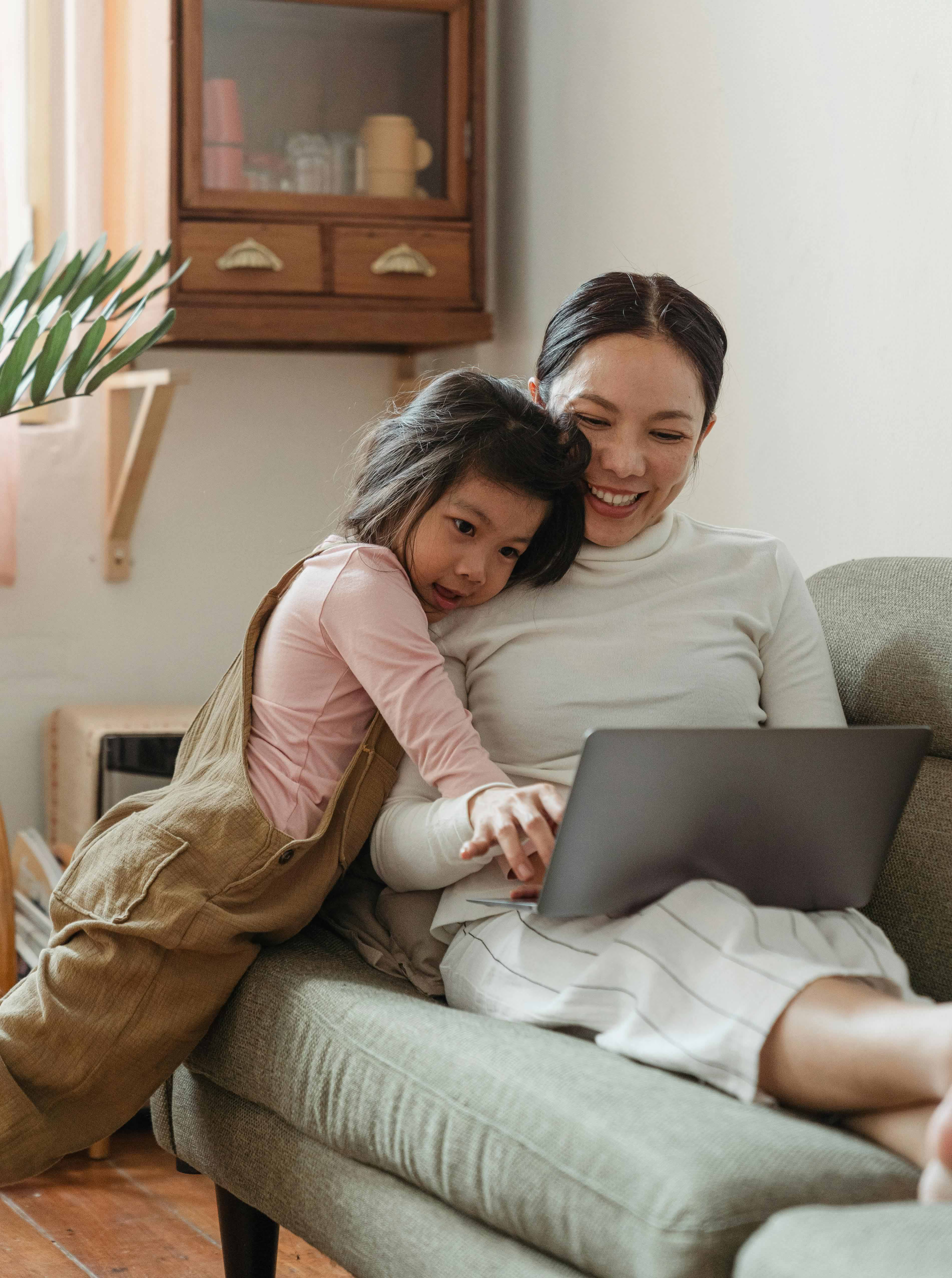 Mother & daughter looking at laptop together