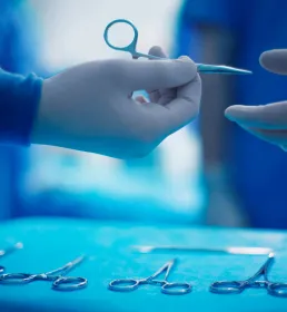 doctor passing scissors