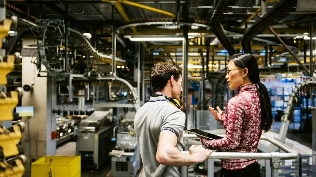 Consultant reviewing risk in a factory Consultant reviewing risk in a factory