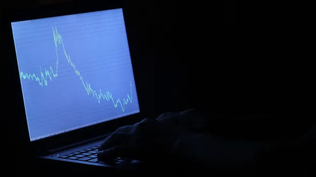 Studying a stock market graph on a screen Studying a stock market graph on a screen
