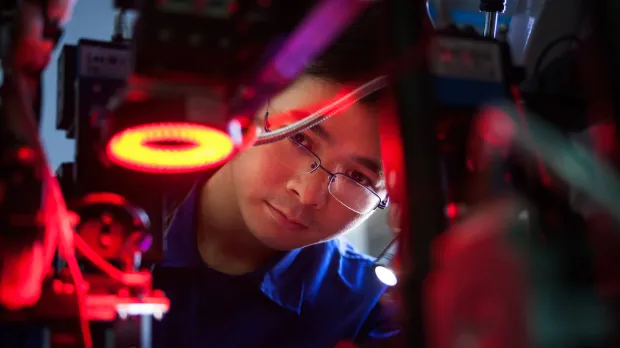 A man watching an industrial lazer