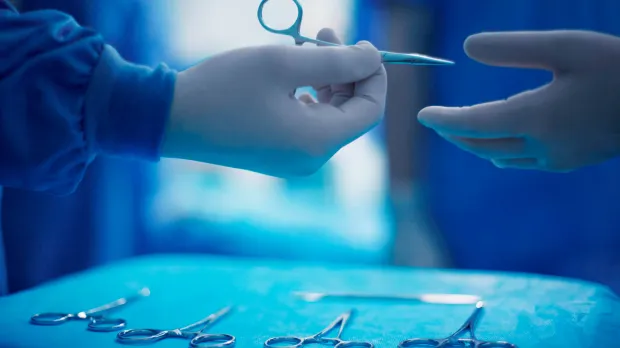 doctor passing scissors
