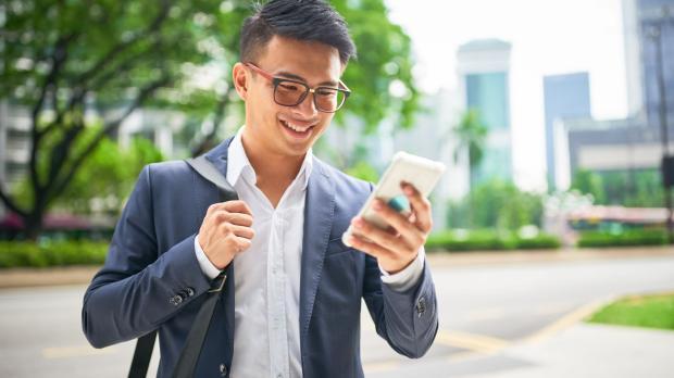 Young asian businessman on smartphone