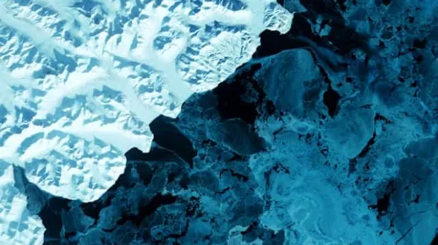 The eastern side of Russia's Kamchatka Peninsula juts into the Pacific Ocean west of Alaska. In this winter image, a volcanic terrain is hidden under snow-covered peaks