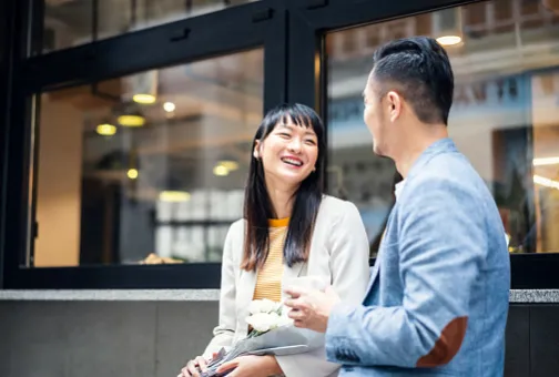 Smiling professionals enjoying a relaxed conversation outdoors