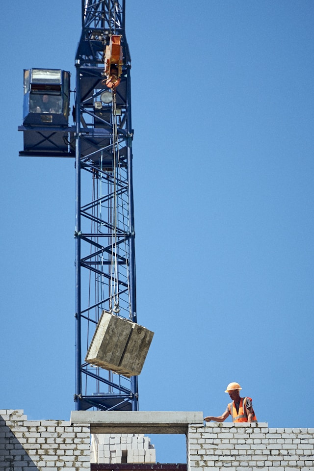 Crane dropping concrete blocks on building site