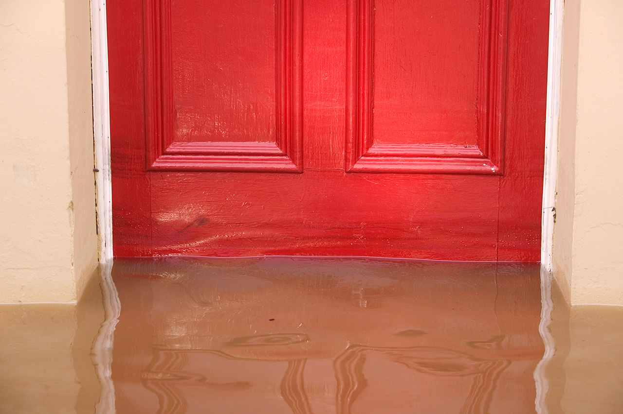Flood water at a red door