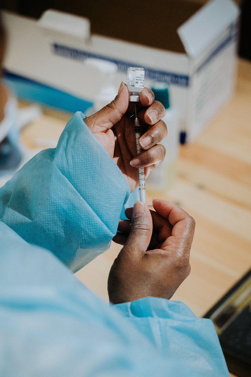 Medical professions drawing fluid from a vile