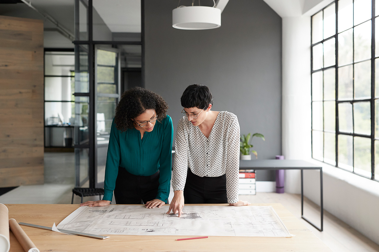 Two people looking over drawings