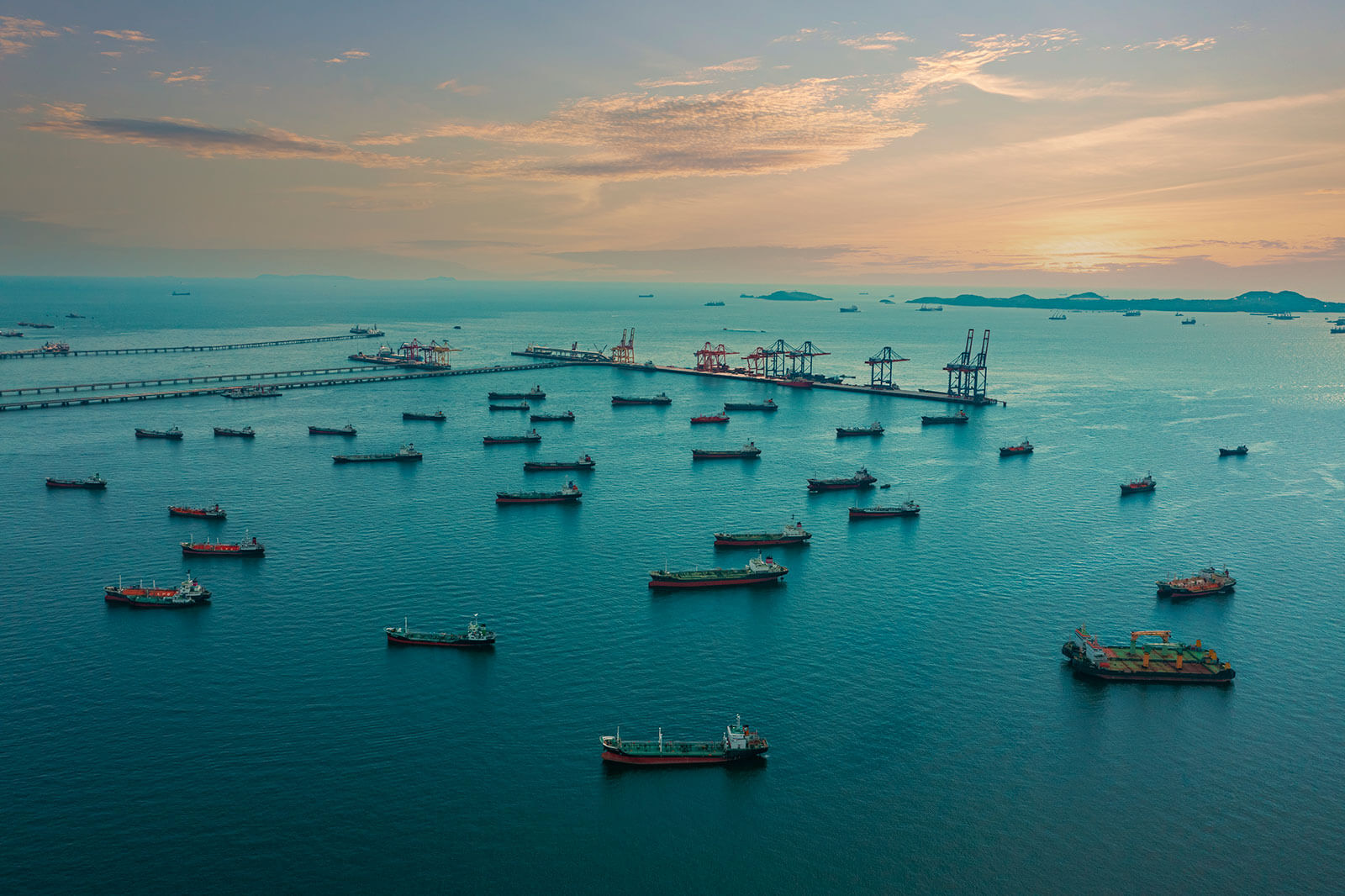 Aerial view of busy shipping port with cargo ships and tankers in ocean harbor, global maritime trade, logistics, and international freight transportation.