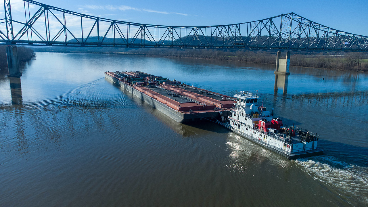 Barge being pushed under a bridge