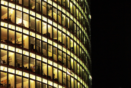 Glass office building lit up at night