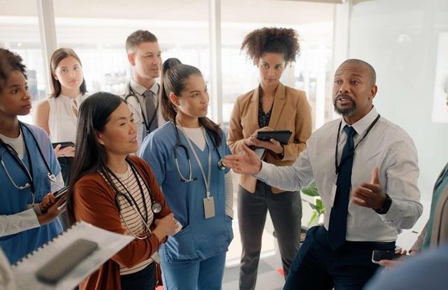 Healthcare administrator talking to staff