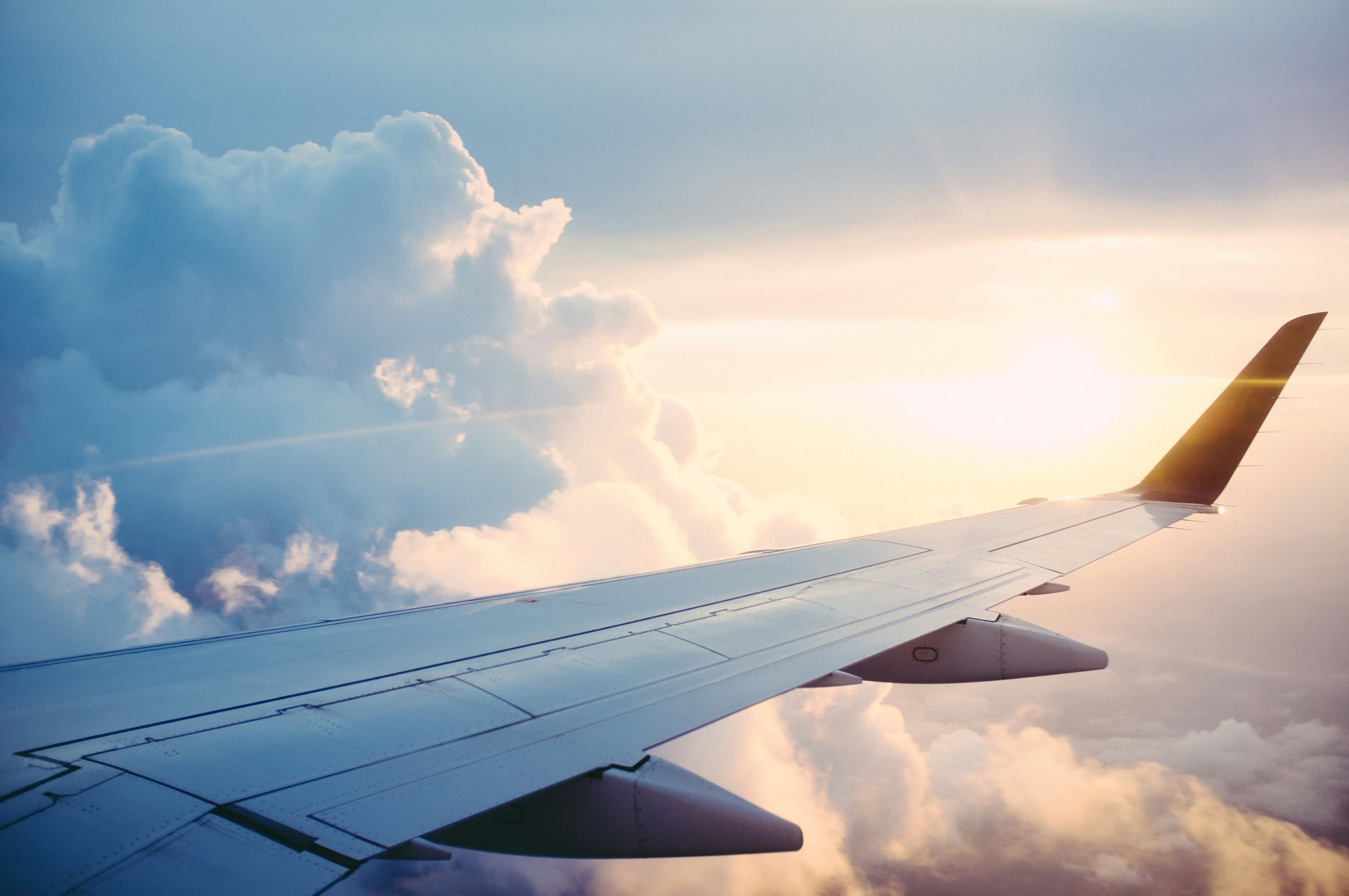 Wing of commercial plane at sunset