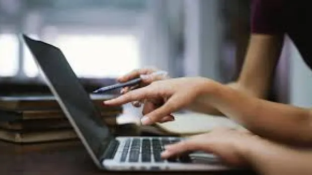 Hands on a computer keyboard